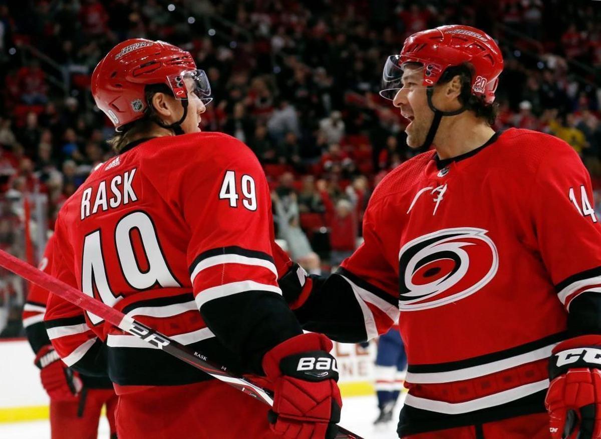 The Canes' Victor Rask (49) celebrates his goal with Justin Williams (14) during the first period against the Washington Capitals at PNC Arena on Jan. 2, 2018.