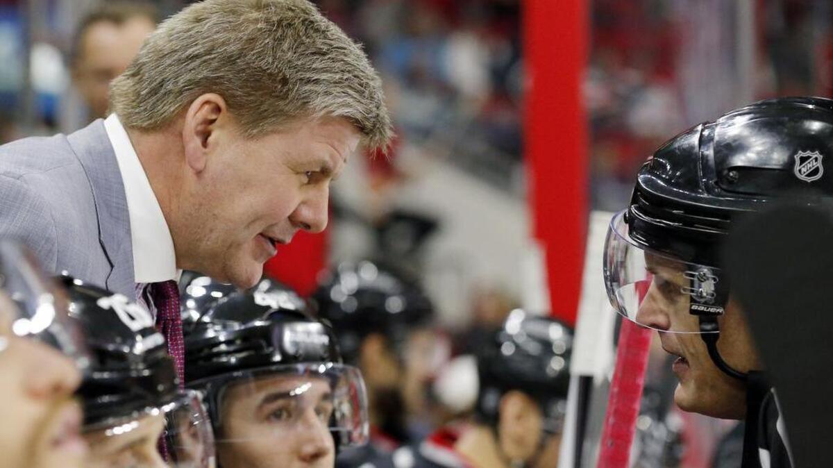 Hurricanes’ coach Bill Peters confers with an official during a game against the Canucks on Jan. 15. Peters is on Canada’s World Cup of Hockey coaching staff.