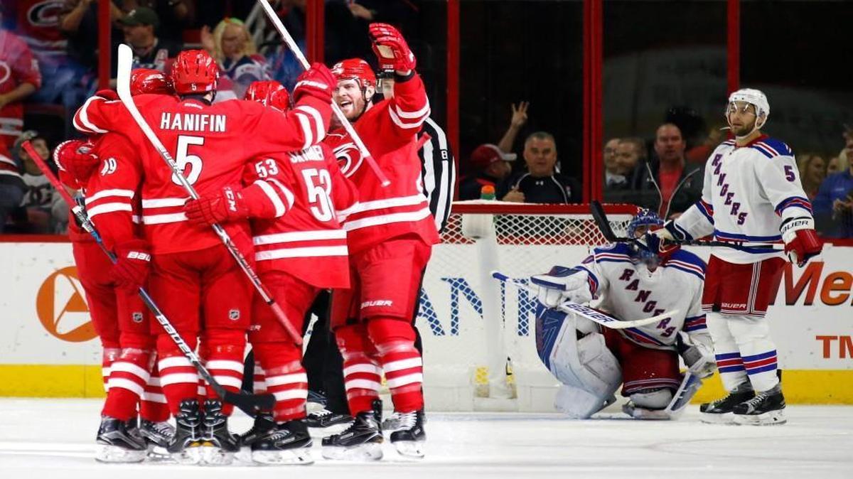 The Canes' celebrate the team's third goal during the second period of their home opener against the New York Rangers at PNC Arena.