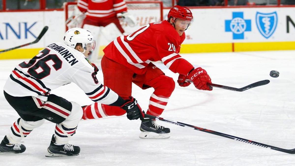 The Carolina Hurricanes' Riley Nash (20) and the Chicago Blackhawks' Teuvo Teravainen (86) go for the puck during the first period at PNC Arena in Raleigh.