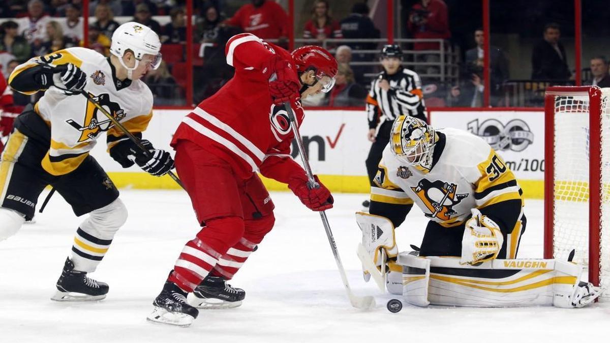 The Canes' Jeff Skinner (53) is denied at the goal by the Pittsburgh Penguins' Olli Maatta (3) and goalie Matt Murray (30) during the second period at PNC Arena.