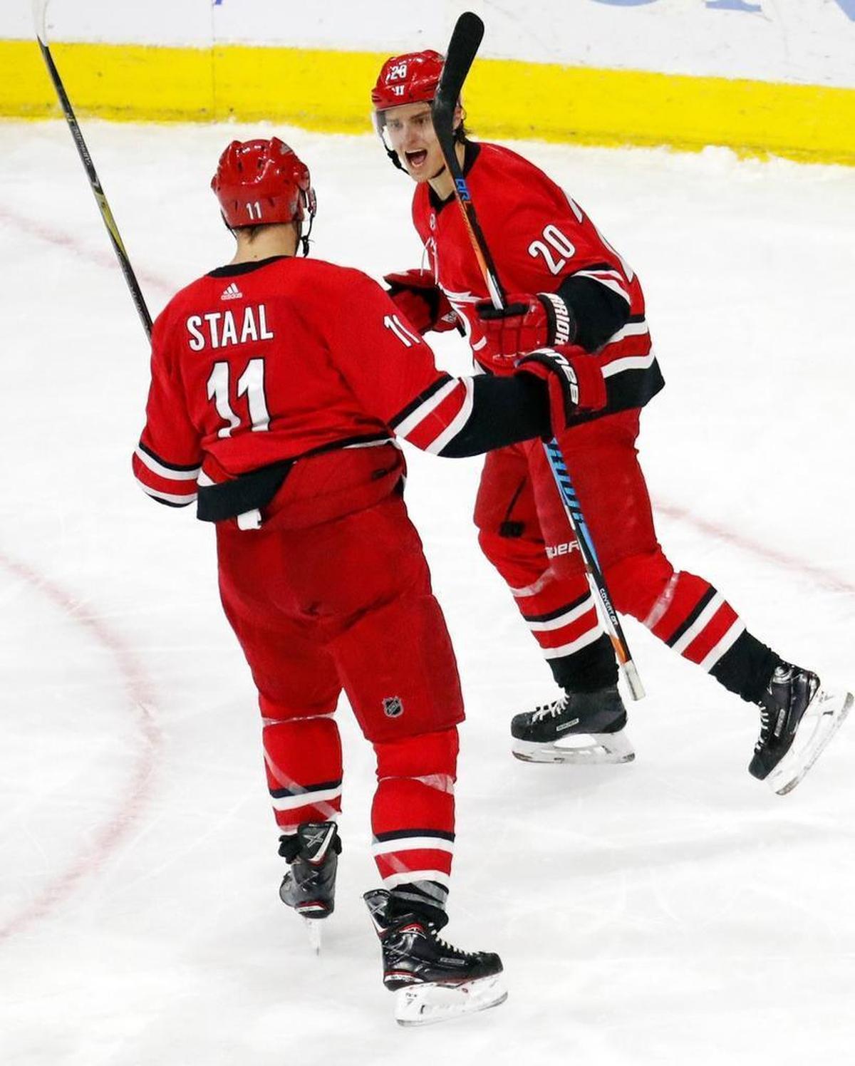 The Canes' Sebastian Aho (20) celebrates his first goal with Jordan Staal (11) during the third period of an NHL game played between the Carolina Hurricanes and the Montreal Canadiens at PNC Arena in Raleigh, N.C. on Dec. 27, 2017. The Canes beat the Canadiens 3-1.