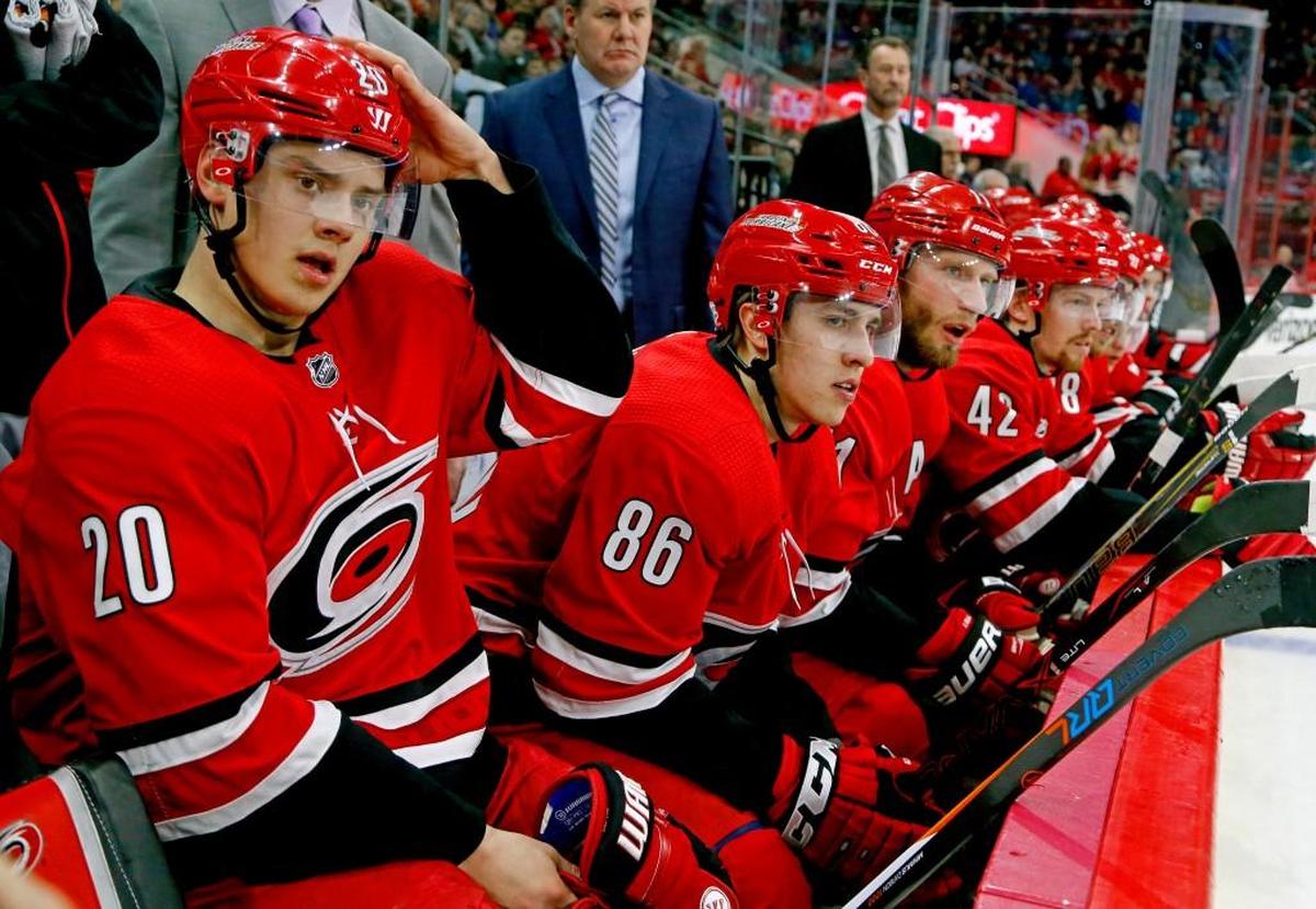 The Canes' Sebastian Aho (20), Teuvo Teravainen (86) and Jordan Staal (11) watch the action during the first period of an NHL game played between the Carolina Hurricanes and the San Jose Sharks at PNC Arena on Feb. 4, 2018. The Sharks beat the Canes 3-1.