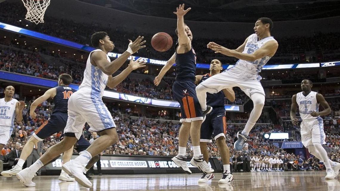 North Carolina’s Marcus Paige (5) passes to teammate Isaiah Hicks (4) against Virginia’s Evan Nolte (11) during the ACC tournament championship at the Verizon Center in Washington, D.C.