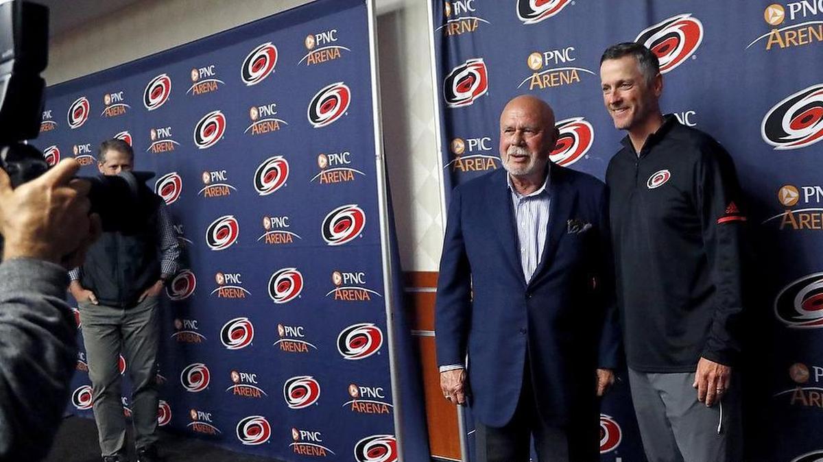 Former majority owner of the Carolina Hurricanes Peter Karmanos, left, and new buyer and majority owner Thomas Dundon pose for the team photographer.