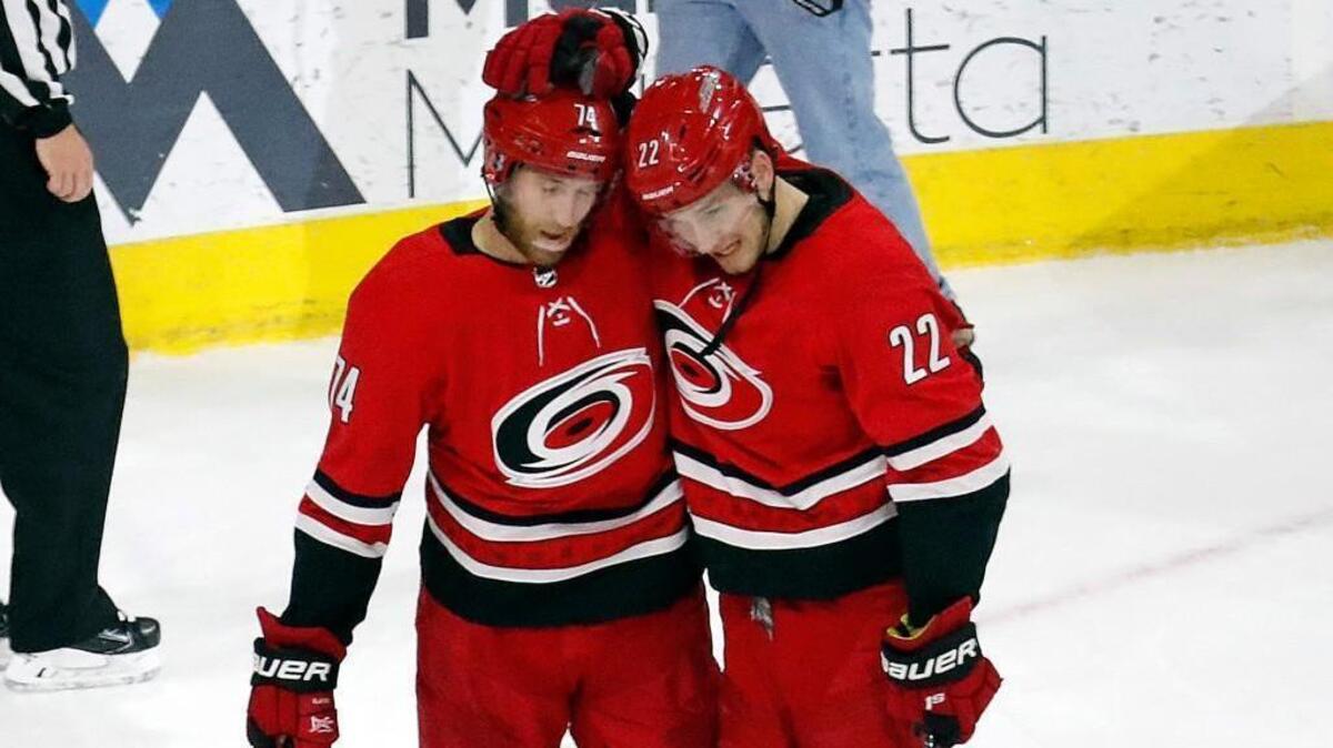 The Canes' Jaccob Slavin (74) and Brett Pesce (22) celebrate together at the conclusion of an NHL game played between the Carolina Hurricanes and the Pittsburgh Penguins at PNC Arena in Raleigh, N.C. on Dec. 29, 2017. The Canes beat the Penguins 2-1.