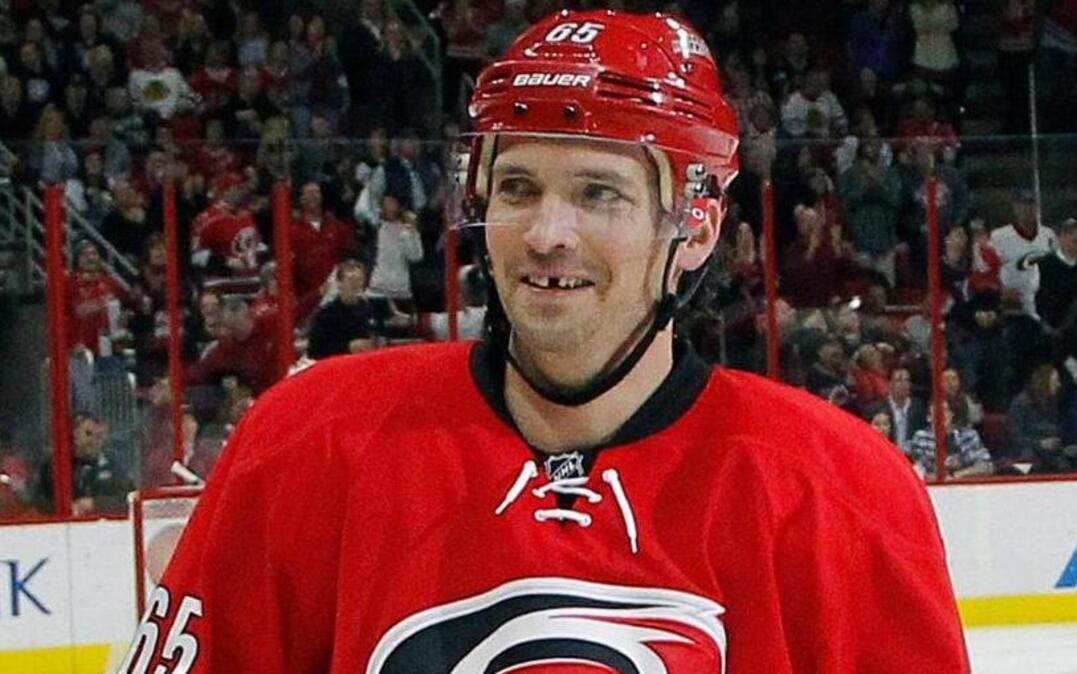 The Carolina Hurricanes' Ron Hainsey (65) flashes a smile after the team scored during the second period of an NHL game played between the Carolina Hurricanes and the Chicago Blackhawks at PNC Arena on Jan. 26.