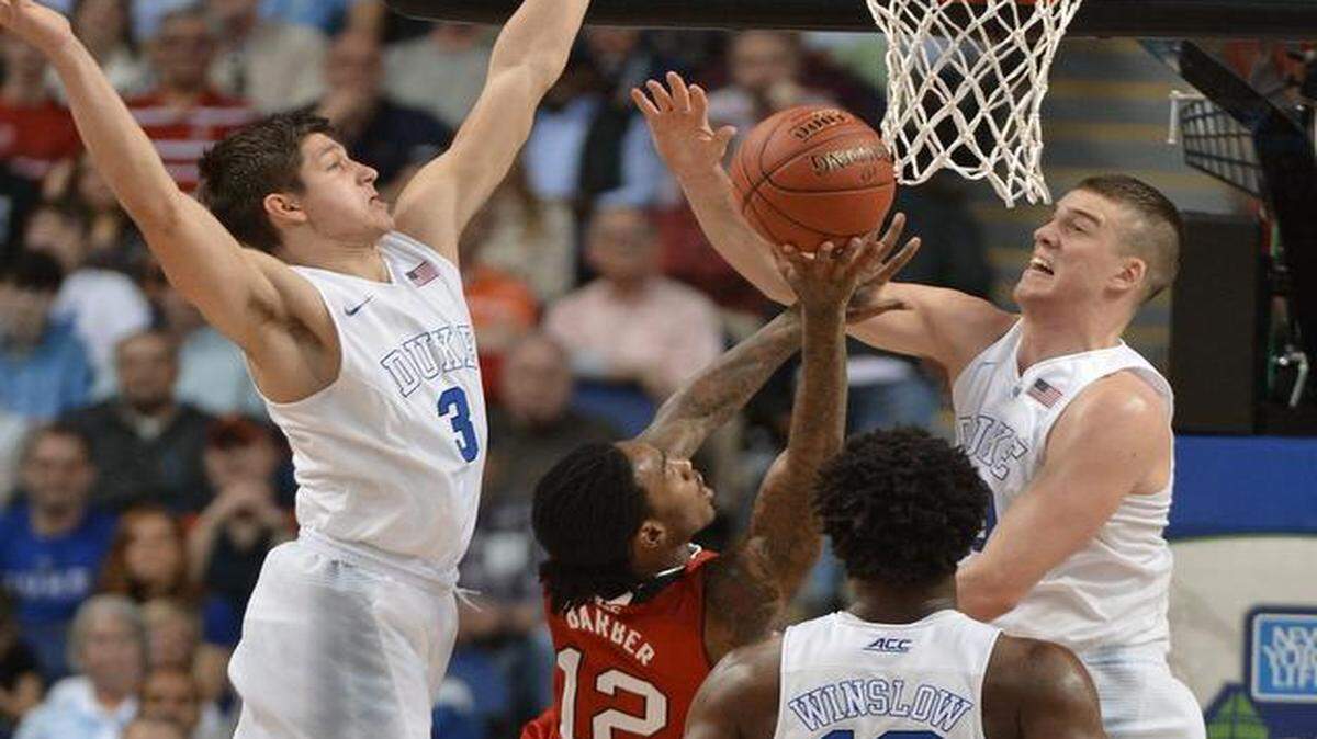 
Duke’s Grayson Allen (3) and Marshall Plumlee (40) block a shot by N.C. State’s Cat Barber (12) in the first half of play in the Atlantic Coast Conference basketball tournament at the Greensboro Coliseum.
