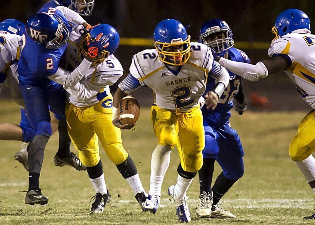 Garner's Nyheim Hines (2) breaks open for a long run to set up the Trojans' third quarter touchdown against Wake Forest on December 5, 2014 at Wake Forest High School in Wake Forest.