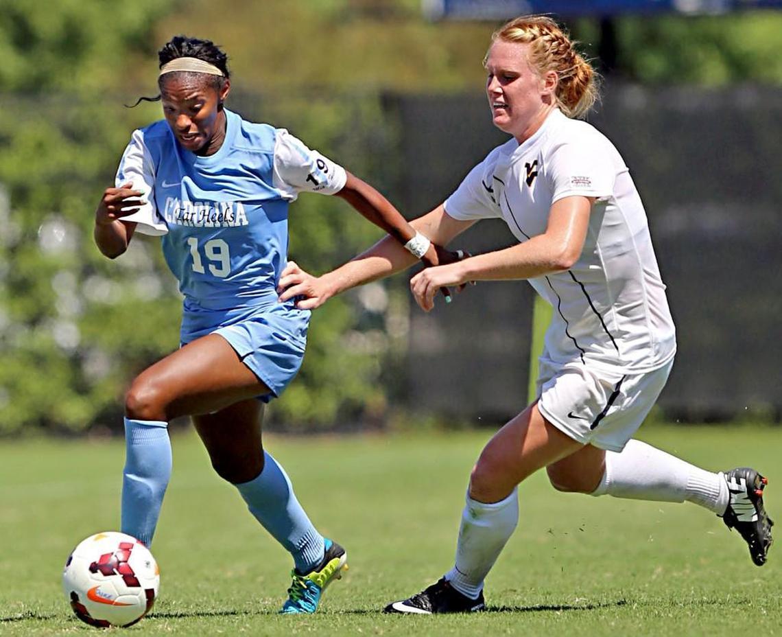 UNC's Crystal Dunn beats West Virginia's Leah Emaus to the ball in the second period during the Duke Nike Classic women's soccer tournament at Koskinen Stadium in Durham, N.C. on Sunday, September 8, 2013.