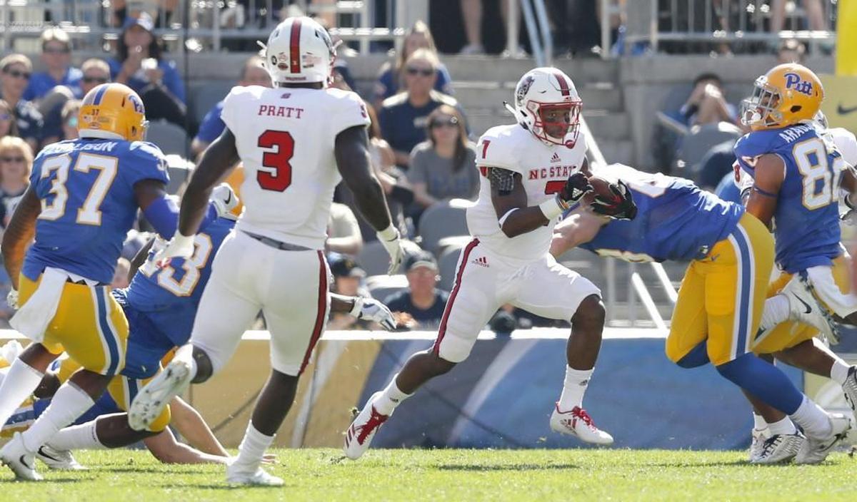 N.C. State's Nyheim Hines (7) scores on a 92-yard punt return during the first half of N.C. State's game against Pittsburgh at Heinz Field in Pittsburgh on Oct .14, 2017.