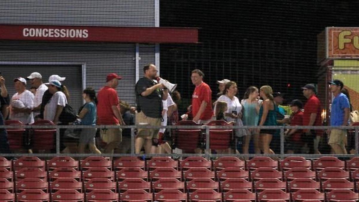 Fans are directed towards the exits after N.C. State's game against Coastal Carolina is postponed because of weather in the ninth inning in the Raleigh Regional of the 2016 NCAA Division I Men’s Baseball Championship at Doak Field in Raleigh, N.C., Saturday, June 4, 2016.