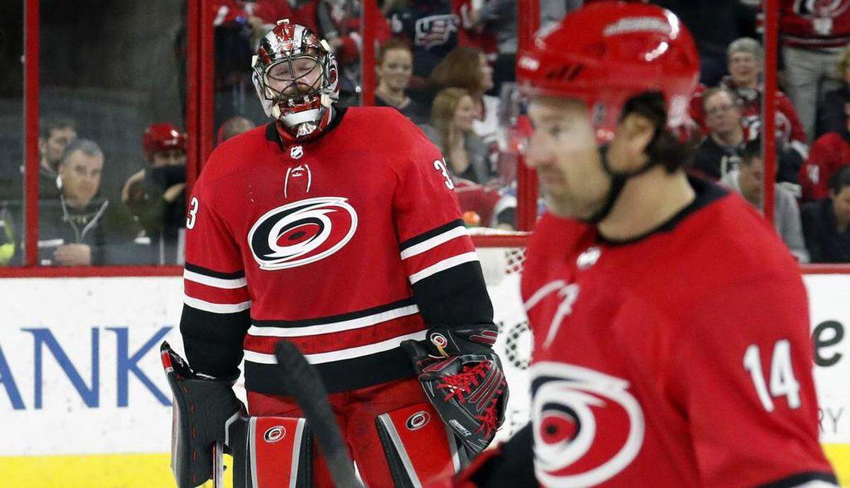 The Canes' Scott Darling (33) reacts as he is pulled from the game after giving up the third goal during the first period of an NHL game played between the Carolina Hurricanes and the Las Vegas Golden Knights at PNC Arena in Raleigh, N.C., on Jan. 21, 2018. Justin Williams (14) is at right. The Knights beat the Canes 5-1.