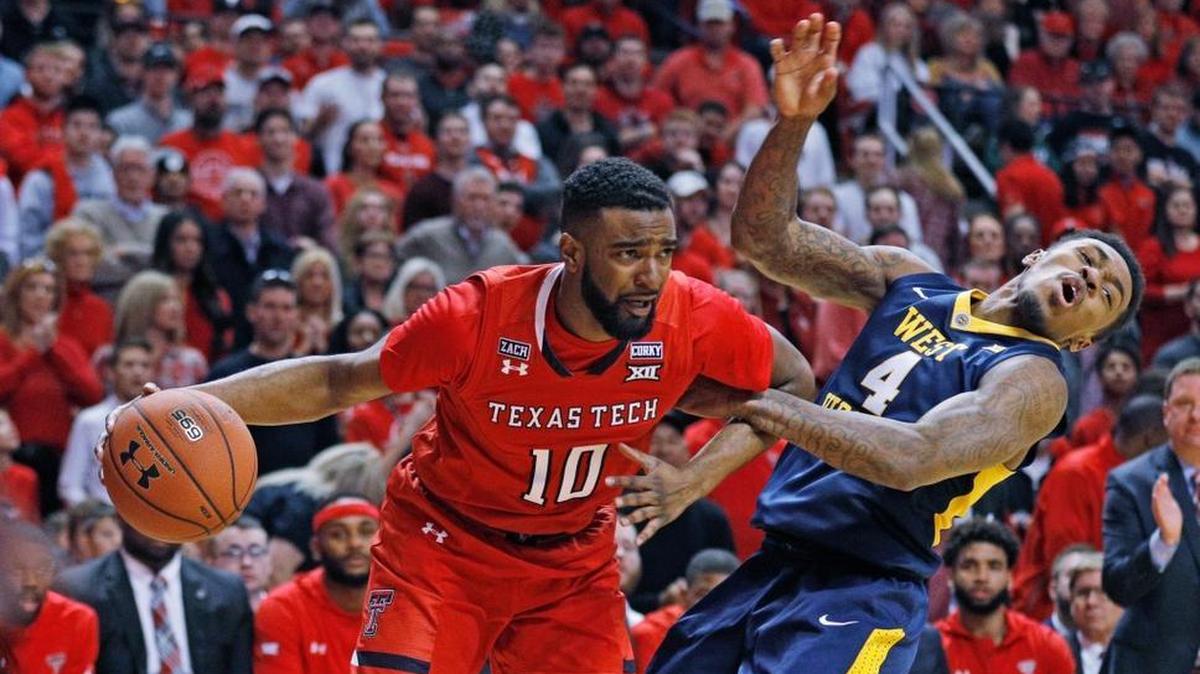 Texas Tech's Niem Stevenson (10) pushes away West Virginia's Daxter Miles (4) during the first half of an NCAA college basketball game Saturday, Jan. 13, 2018, in Lubbock, Texas.