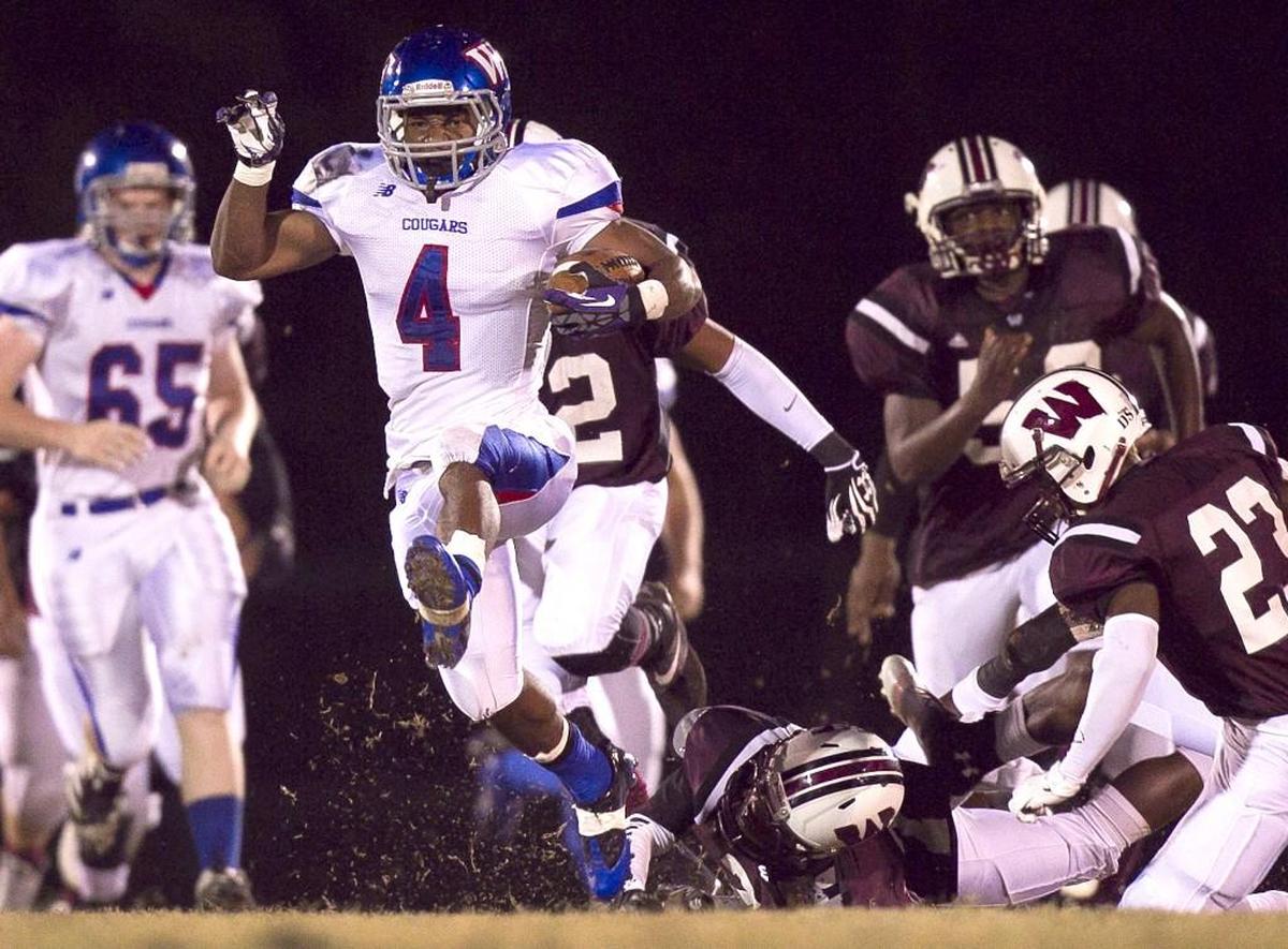 Wake Forest High School's Bryce Love (4) races 73-yards for a touchdown during a game against Wakefiel in 2013.