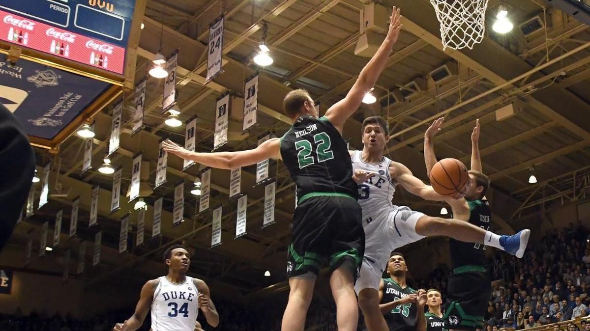 Duke guard Grayson Allen (3) splits Utah Valley forward Isaac Neilson (22) and guard Conner Toolson (11) in the first half.