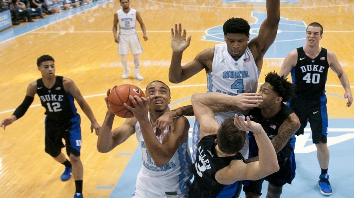 North Carolina’s Brice Johnson secures an offensive rebound against Duke’s Grayson Allen on Feb. 17, 2016. The two schools’ dominance of the ACC has been threatened by the arrival of Big East teams.