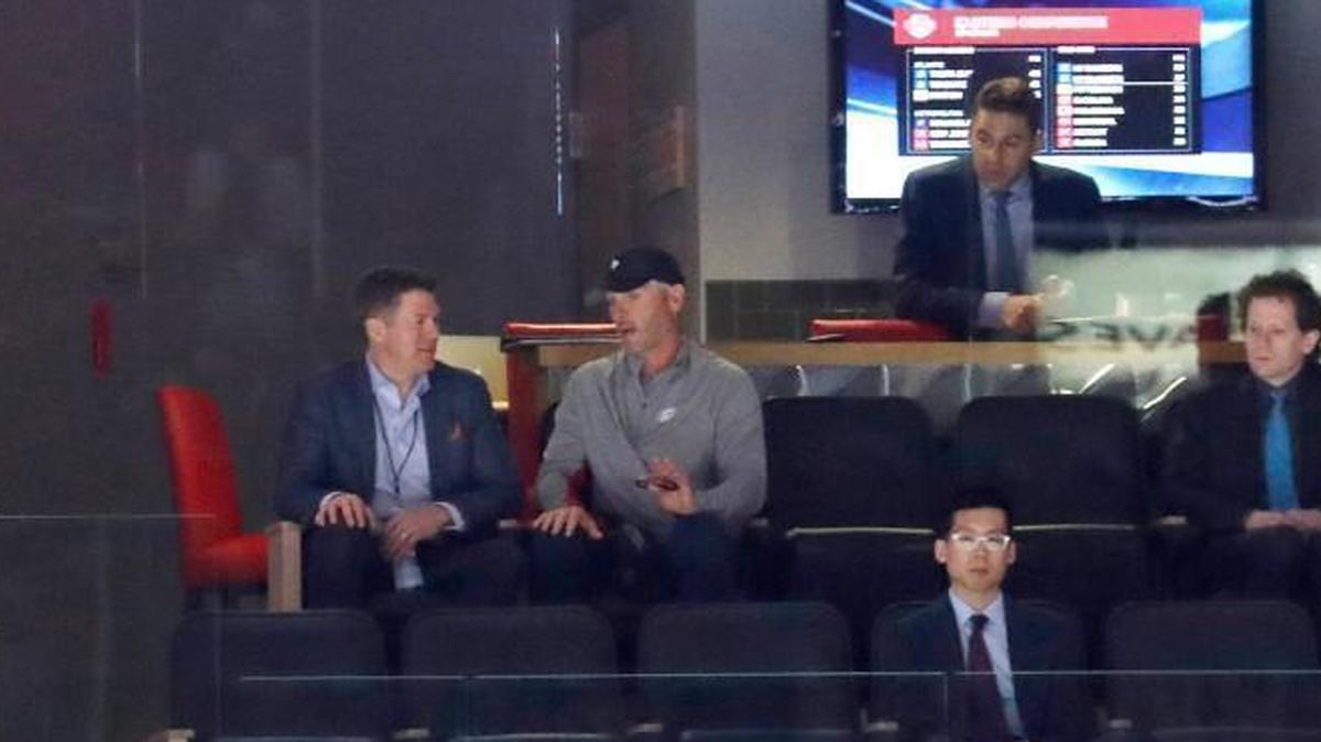 Dallas businessman Tom Dundon, center, in ball cap, watches game between the Carolina Hurricanes and the Columbus Blue Jackets at PNC Arena on Dec. 16, 2017.