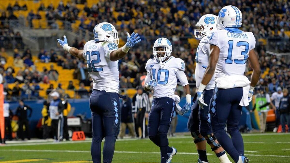 North Carolina’s Brandon Fritts, left, celebrates with teammates after an 11-yard touchdown reception against Pitt.