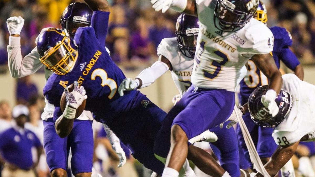 East Carolina’s Anthony Scott collides with Western Carolina defenders on Sept. 3. N.C. State heads to Greenville to play the Pirates on Saturday.