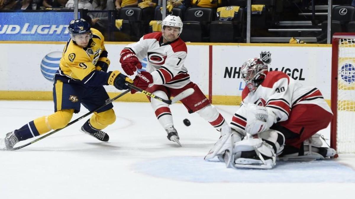 
Filip Forsberg (9) of the Nashville Predators fires a shot as Ryan Murphy (7) of the Carolina Hurricanes defends while Cam Ward (30) makes the save during the first period at Bridgestone Arena. 
