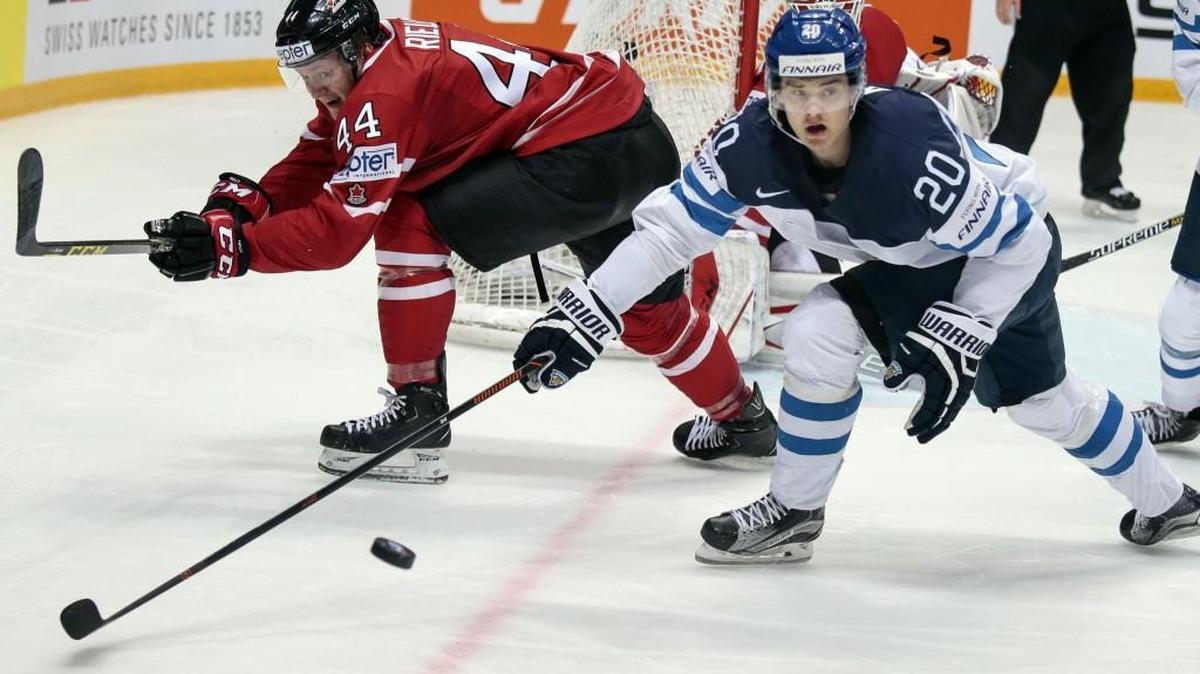 Finland’s Sebastian Aho, center, and Canada’s Morgan Rilles, left, battle for the puck during the Ice Hockey World Championships final match between Finland and Canada, in Moscow, Russia, on Sunday, May 22, 2016. (AP Photo/Pavel Golovkin)