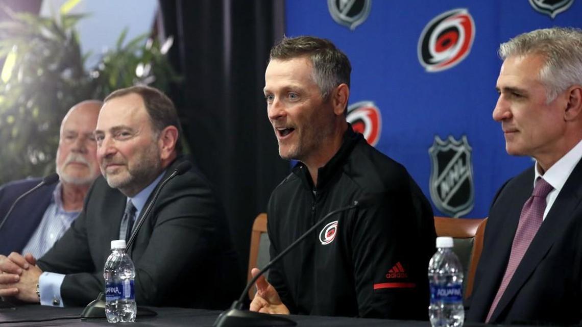 Former majority owner Peter Karmanos, left, NHL commissioner Gary Bettman, second from left, Thomas Dundon, new Hurricanes majority owner, second from right and Canes' general manager Ron Francis speak at a press conference where Dundon was announced as the buyer and new majority owner of the Carolina Hurricanes at PNC Arena on Jan. 12, 2018.