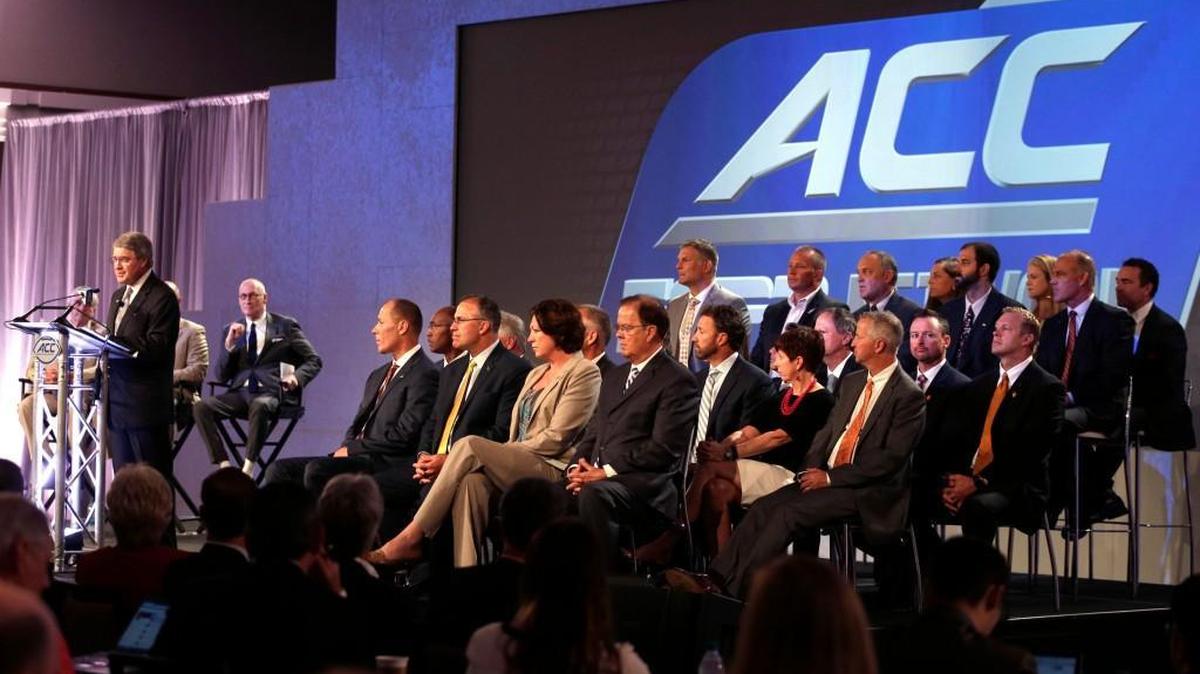 Commissioner John Swofford, left, with ACC coaches as he announces an ACC/ESPN Network during a news conference at the Atlantic Coast Conference Football Kickoff in Charlotte Thursday. (AP Photo/Chuck Burton)
