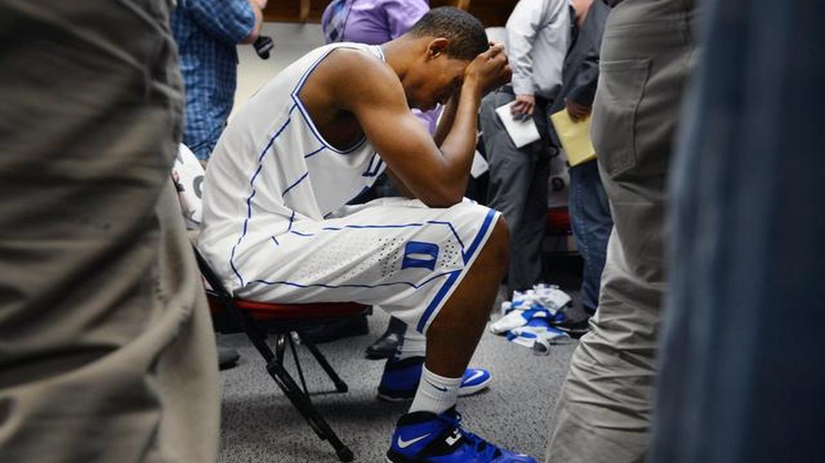 
Members of the media mill around Duke forward Rodney Hood in the locker room after the Blue Devils were upset by Mercer 78-71 in their opening game of the 2014 NCAA  Basketball Tournament at the PNC Arena in Raleigh.
