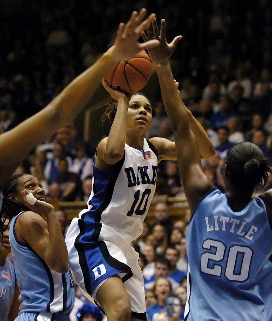 Duke’s Lindsey Harding goes up for two of her first half points against UNC’s Alex Miller (at left) and Camille Little (20) Feb.25, 2007 in their season finale at Cameron Indoor Stadium on the Duke Campus at Durham.