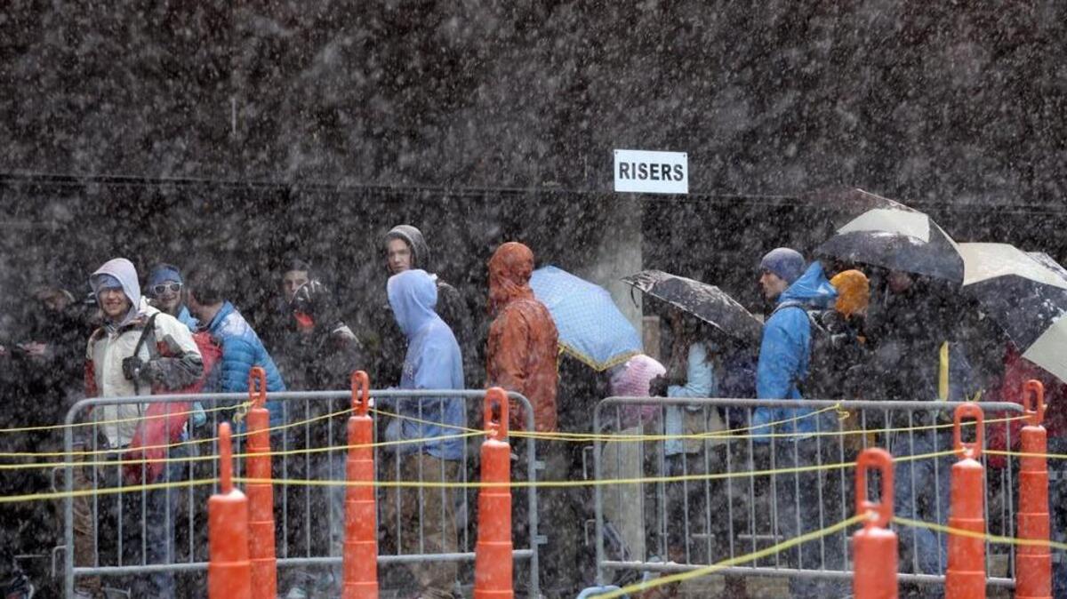 The snow and winds picked up Feb. 12, 2014 as UNC students lined up outside of the Smith Center for good seats for that night's UNC-Duke. The fast-moving snow and then ice storm Wednesday afternoon into Thursday forced a postponement of the game.
