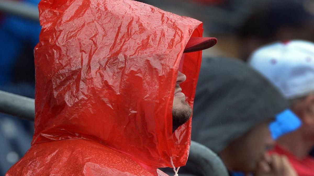 
NC State baseball fan Chris Hathcock doesn't let a little rain bother him as he watches the Wolfpack play Notre Dame at the Durham Bulls Athletic Park in Durham, Thursday, May 21, 2015 during the ACC Baseball Tournament.
