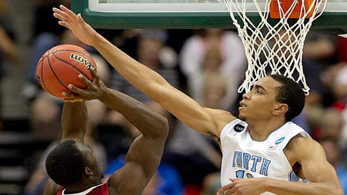 
UNC’s Brice Johnson blocks a shot by Arkansas’ Alandise Harris on Saturday night during the first half in the third round of the NCAA tournament in Jacksonville, Fla.
