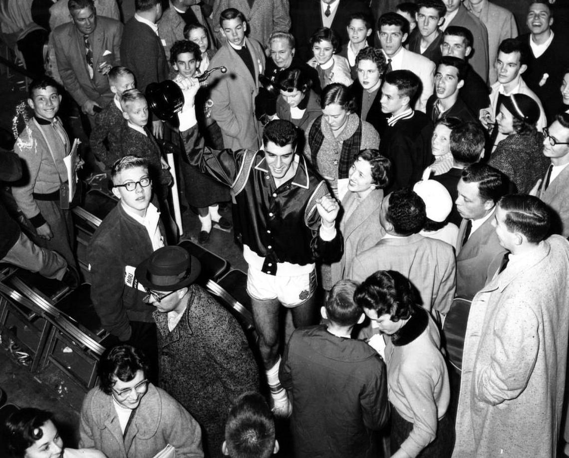 UNC’s Lennie Rosenbluth (center) is surrounded by Tar Heel fans after the team defeated Kansas in triple overtime to win the NCAA title in 1957.