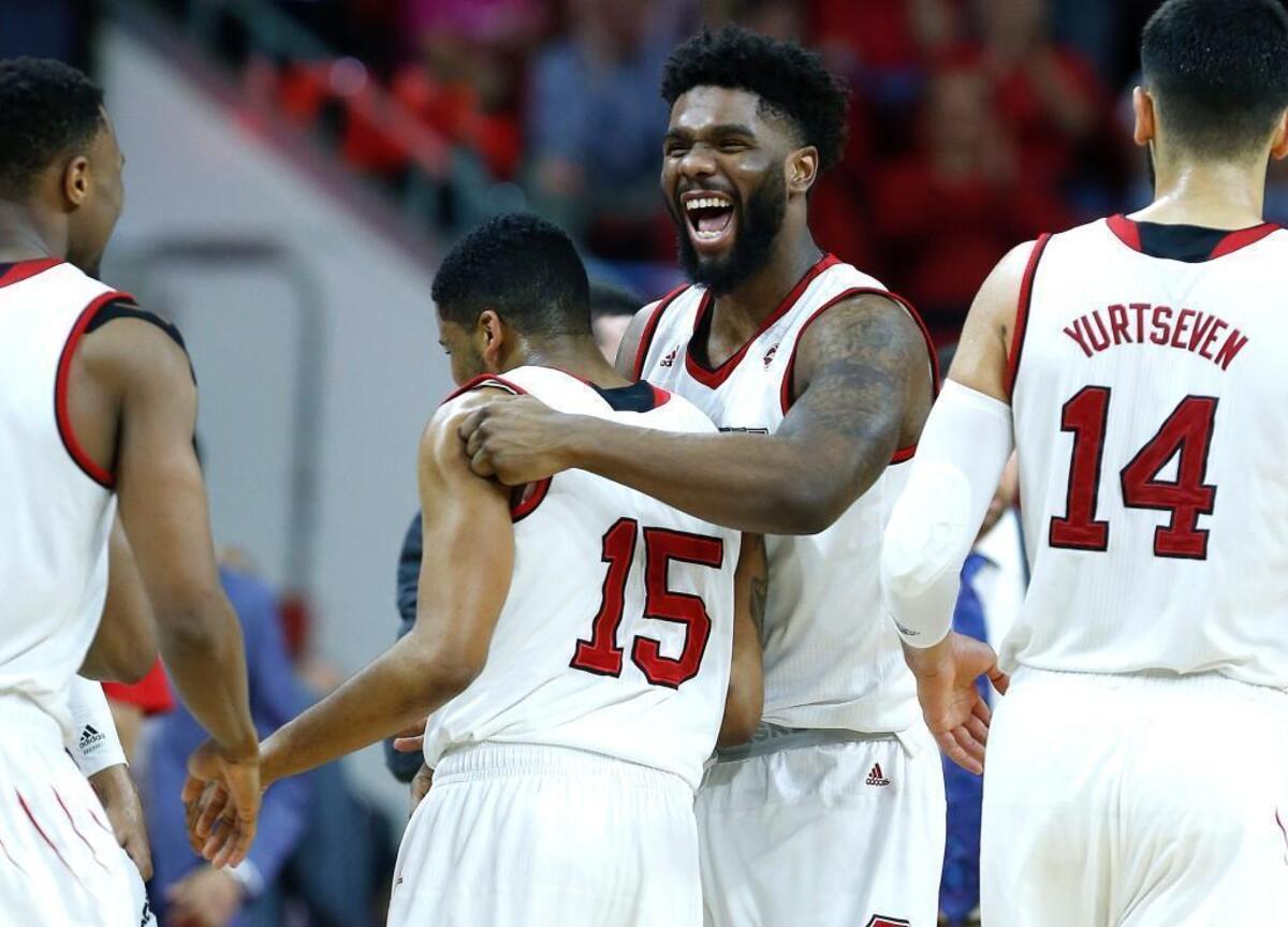 N.C. State's Lennard Freeman (1) congratulates Sam Hunt (15) during a timeout in the Wolfpack’s victory over Boston College at PNC Arena in Raleigh, Tuesday, Feb. 20, 2018.