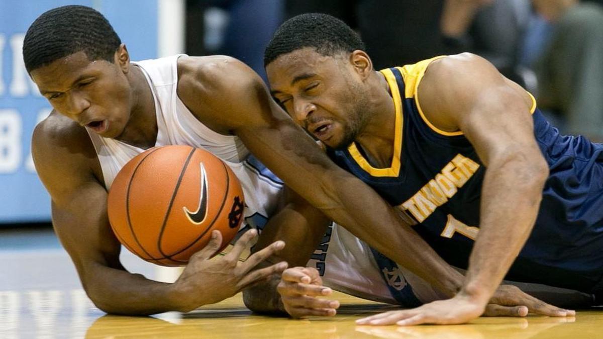 North Carolina’s Kenny Williams dives after a loose ball with Chattanooga’s Greg Pryor during the first half at the Smith Center in Chapel Hill.
