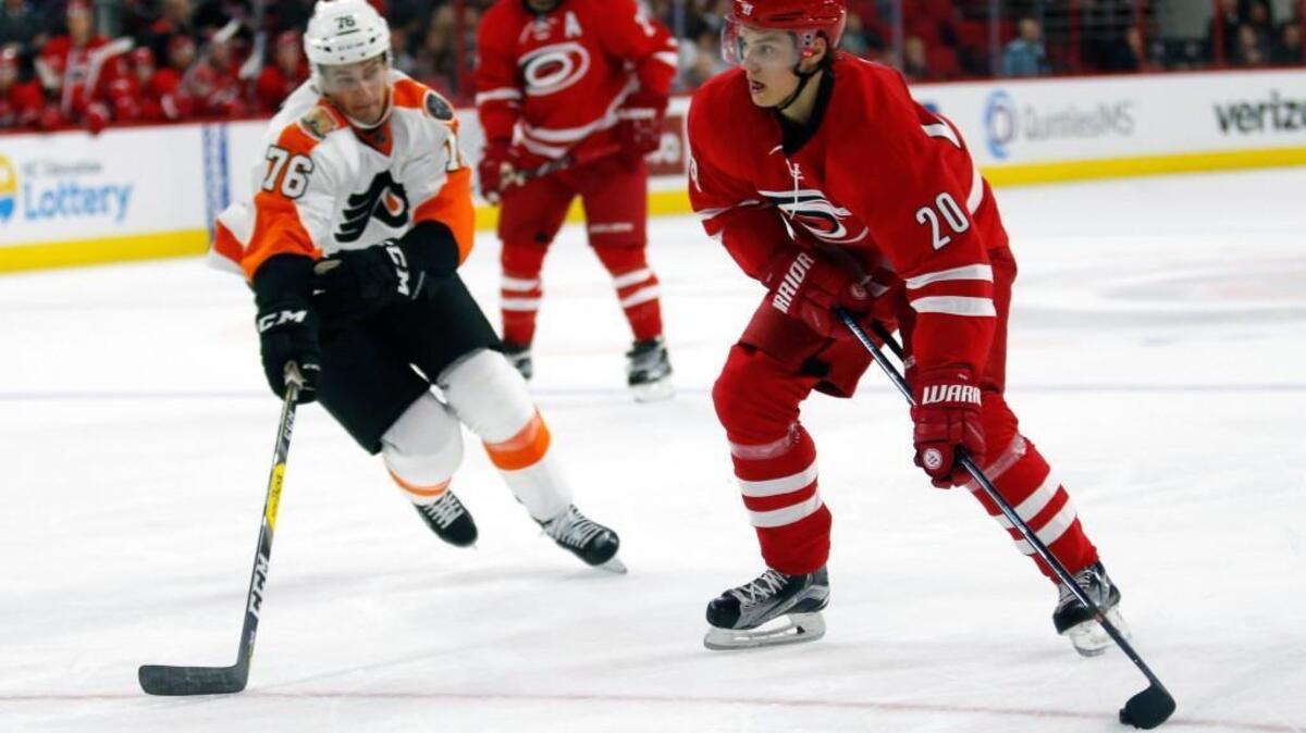 The Canes Sebastian Aho (20) drives against the Philadelphia Flyers' Chris VandeVelde (76) at PNC Arena on Oct. 30.