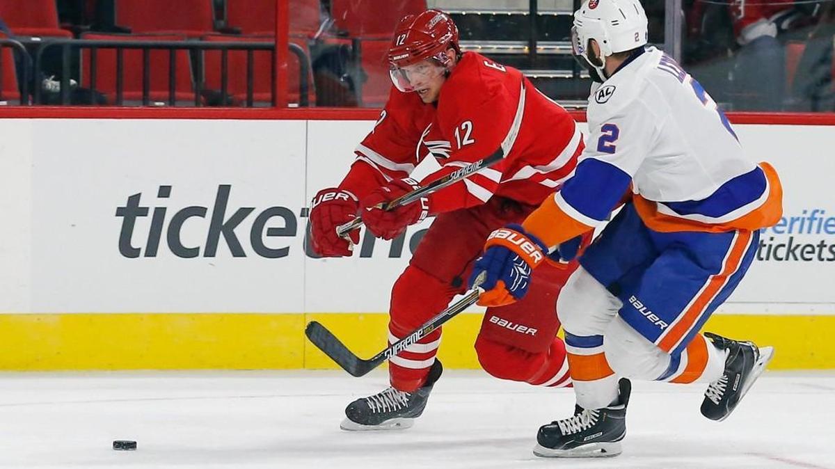 The Canes Eric Staal (12) drives against the New York Islanders' Nick Leddy (2) during the first period of an NHL game played between the Carolina Hurricanes and the New York Islanders at the PNC Arena on Saturday.