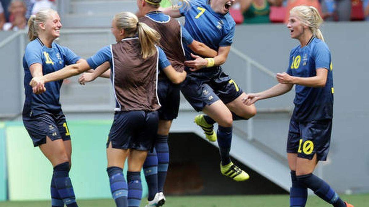 Sweden players celebrate after Stina Blackstenius, left, scored her team's first goal during a quarter-final match of the women's Olympic football tournament between the United States and Sweden in Brasilia Friday Aug. 12, 2016.