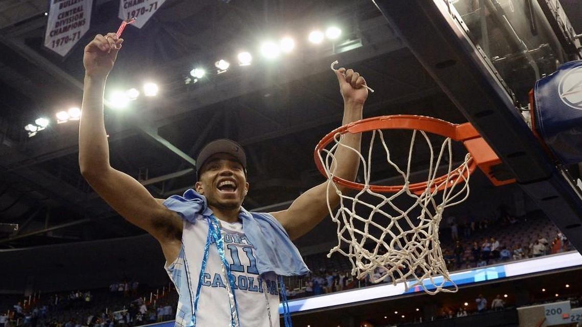 UNC’s Brice Johnson celebrates after cutting down his part of the net after the Tar Heels won the ACC tournament.