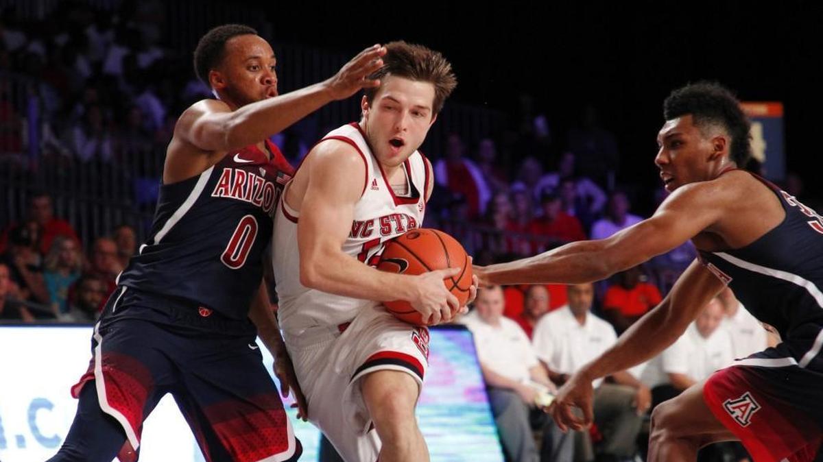 N.C. State’s Braxton Beverly, middle, rives past Arizona’s Parker Jackson-Cartwright, left, and Allonzo Trier in the Wolfpack’s 90-84 upset win over the Wildcats on Wednesday.
