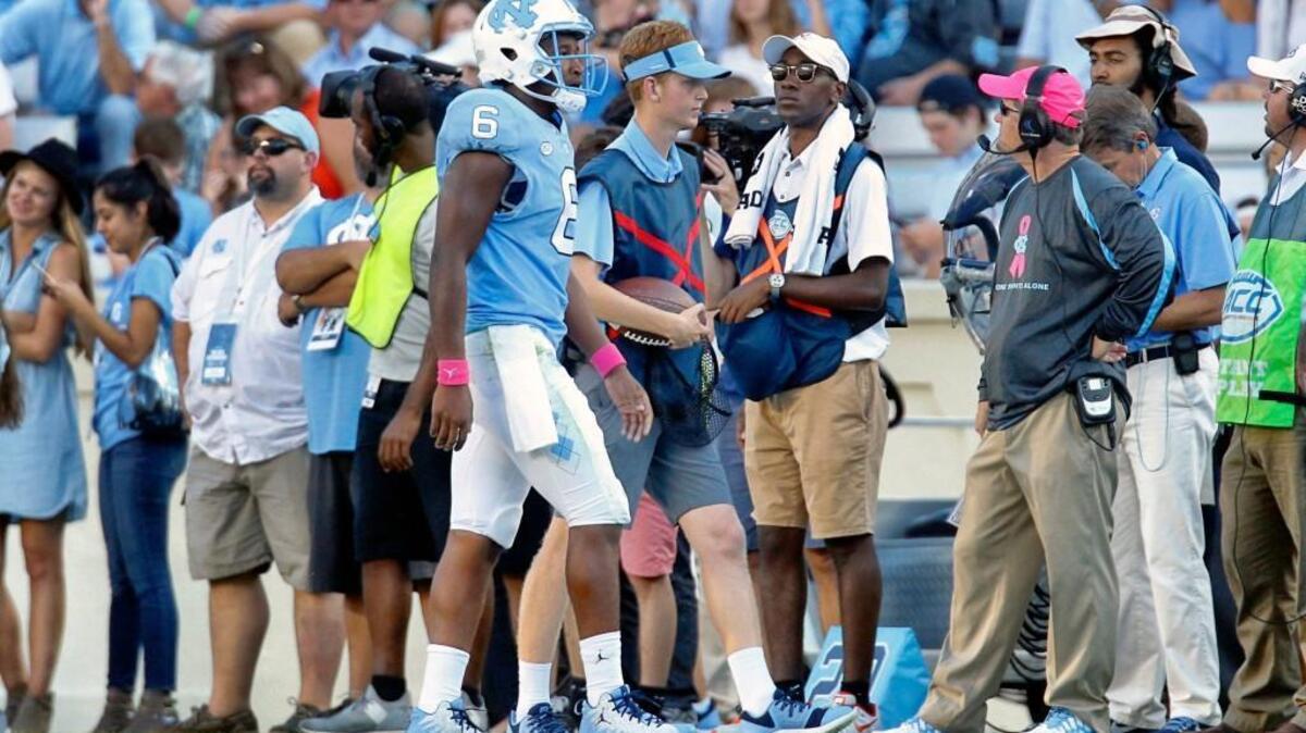 UNC QB Brandon Harris (6) comes back to the bench after throwing an interception during the third quarter in the loss to Virginia.