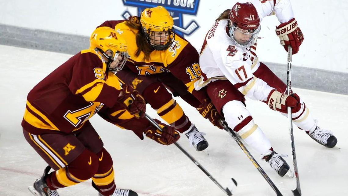 Boston College's Meghan Grieves (17) tries to get past Minnesota's Brook Garzone (18) and Sydney Baldwin during the first period of the women's Frozen Four championship college hockey game in Durham, N.H. Sunday. (AP Photo/Winslow Townson)