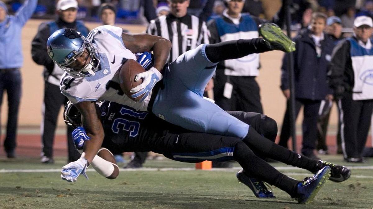 
UNC's Quinshad Davis (14) scores a touchdown as Duke's Breon Borers (31) defends during their game November 19, 2014 at Wallace Wade Stadium in Durham.
