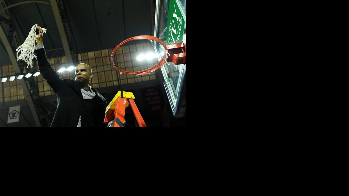 
Harvard coach Tommy Amaker cuts down the net after his team defeated Yale 53-51 in the Ivy League championship playoff game March 14 to clinch the Crimson’s fourth straight appearance in the NCAA tournament.
