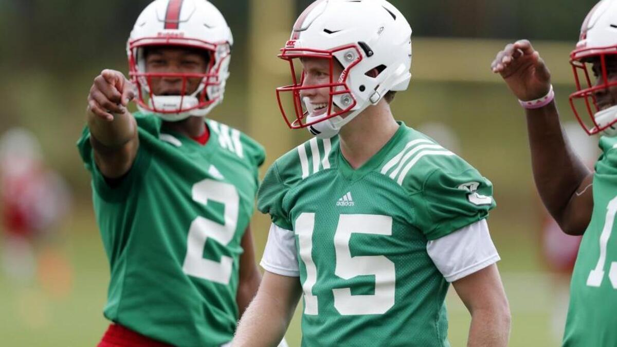 N.C. State quarterback Jalan McClendon (2), left, laughs with quarterback Ryan Finley (15) during N.C. State football's first practice of fall camp at the Curtis and Jacqueline Dail Football Practice Complex on July 29, 2017.