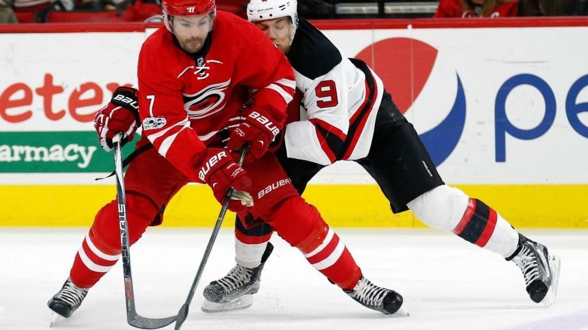 The Carolina Hurricanes' Ryan Murphy (7) battles the New Jersey Devils' Taylor Hall (9) for the puck during the second period of an NHL game played between the Carolina Hurricanes and the New Jersey Devils at PNC Arena in Raleigh, N.C. on Jan. 3, 2017.