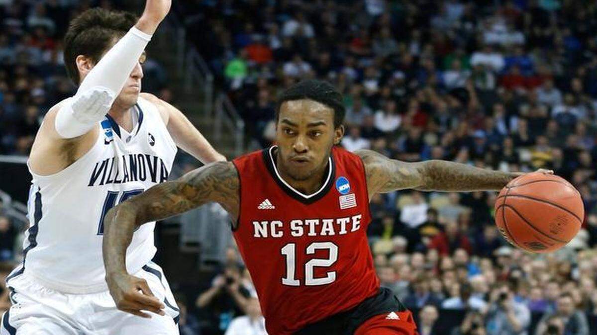 
N.C. State's Cat Barber (12) drives around Villanova's Ryan Arcidiacono (15) during the first half of the Wolfpack's game against Villanova.
