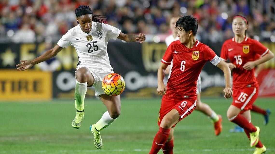United States' Crystal Dunn (25) leaps to settle a pass in front of China's Li Donga during the first half of an international friendly soccer match, Sunday, Dec. 13, 2015, in Phoenix.