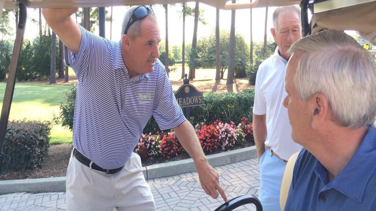 Neal Lancaster, left, gets ready to head onto the course after speaking to the competitors at the SAS Junior Championship at Prestonwood Country Club in Cary on Thursday. “When I was younger, we had nothing like this,” Lancaster said. “At least we didn’t know nothing about it in Smithfield.”